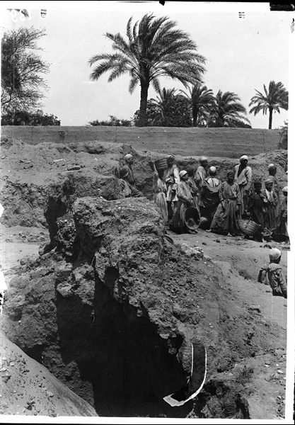 Excavating in the area of the Sun Temple; the garden of Latif can be seen in the background. Schiaparelli excavations.