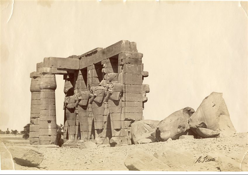 The image depicts four Osiride pillars of Pharaoh Ramesses II in the Ramesseum, West Thebes, built by the same pharaoh. The author's signature is visible at the bottom right. 