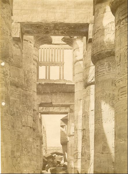 Inside the Great Hypostyle Hall of the Karnak Temple Complex, built by Pharaoh Seti I and completed by his son and successor Ramesses II. Note, at the bottom centre where the author's signature is, some blocks obstructing the passage, as they have not yet been removed.   