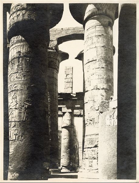 The photograph shows an interior view of the Great Hypostyle Hall, built by Pharaoh Seti I in the Karnak Temple Complex.