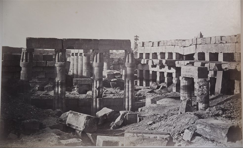 The picture shows the ruins of the Akhmenu (“Festival Hall”), the temple built by ruler Tuthmosis III in the Karnak Temple Complex. Among the ruins, four papyrus columns are still standing. The author's signature can be found at the bottom.