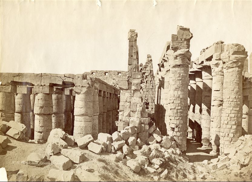 The photograph shows the longitudinal section of the Great Hypostyle Hall of the Karnak Temple Complex together with the ruins of some collapsed walls. The authors' signatures can be seen at the bottom right.