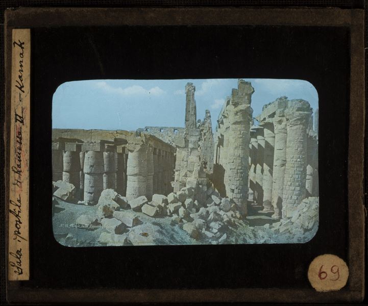Hypostyle Hall columns in the Karnak Temple Complex. This is a 19th-century colour photograph. At the bottom left is the caption and on the right the author's signature.