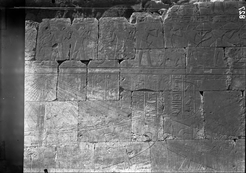 South side of the mortuary temple of Queen Hatshepsut at Deir el-Bahari. Wall scene from the portico in the middle terrace. In the upper register there is a scene of tribute and in the lower, the loading of goods onto Egyptian ships near Punt. 