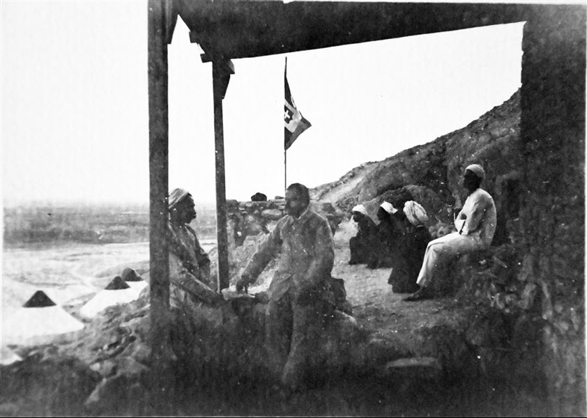 Photograph taken on the veranda of the mud-brick house built at Deir el-Medina during excavations by the Italian Archaeological Mission in 1909. The people photographed are yet to be identified. Angelo Sesana Archive.