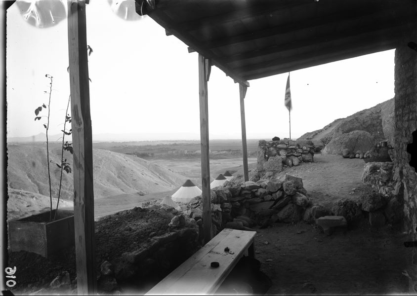 Mission camp, photographed from the veranda of the brick structure, in the direction of the Nile which can be seen in the distance. In the foreground, some photographic equipment is recognisable. Schiaparelli excavations.