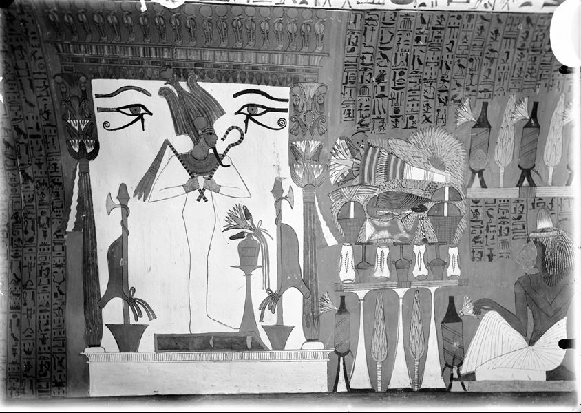 North wall (back) from the tomb of Sennedjem (TT1). The god Osiris is depicted inside a shrine, in front of him is a pile of offerings.   