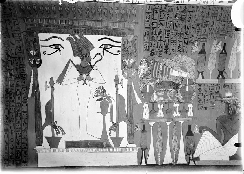 North wall (back) from the tomb of Sennedjem (TT 1). The god Osiris is depicted inside a shrine, in front of him is a pile of offerings.   