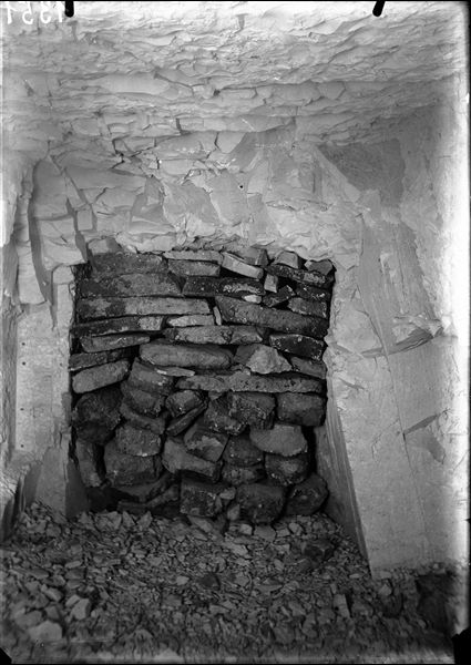 Intact tomb of Kha and Merit. The horizontal corridor leading to the burial chamber is blocked halfway by a wall. Photographed at the time of discovery. Schiaparelli excavations.