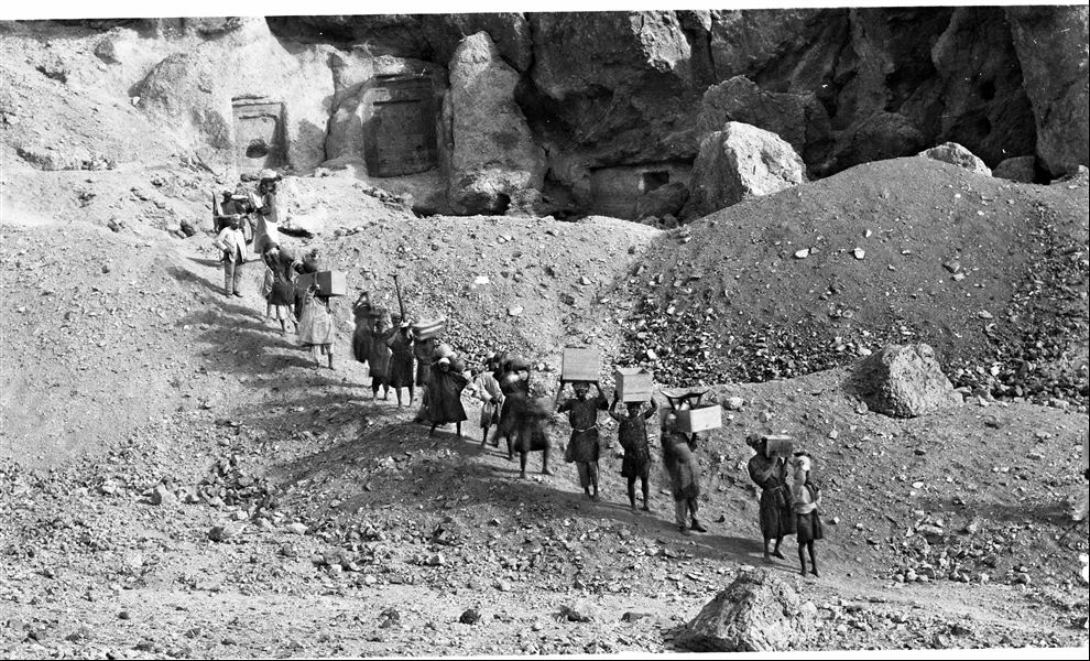 Transporting Kha and Merit’s grave goods out of the tomb, in the direction of the Valley of the Queens. During the process, the workers pass by the rock-cut sanctuary of Ptah and Meretseger. Schiaparelli excavations.