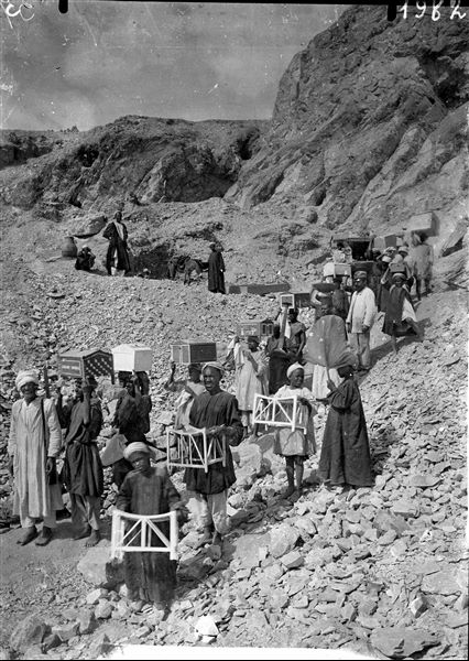 Transporting Kha and Merit’s grave goods out of the tomb, in the direction of the Valley of the Queens. Schiaparelli excavations.