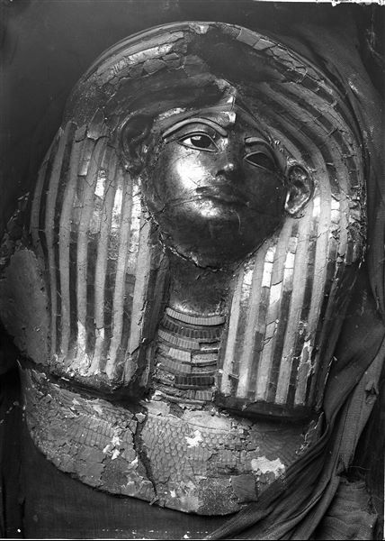 Golden funerary mask of Merit (S.08473), still left in place resting on her mummified corpse.