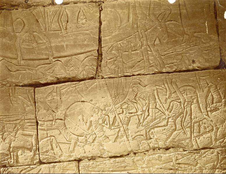 The photograph shows some carved relief scenes from the outer walls of the Temple of Medinet Habu, where Pharaoh Ramesses III depicts his victory over the Sea Peoples. 