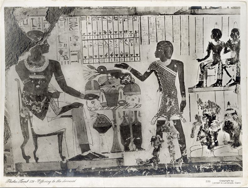 Wall painting scene from the Tomb of Pairi (TT139), who lived in the 18th Dynasty. The scene shows the deceased couple seated in front of a table filled with offerings. Behind, a Sem priest, indentifiable by the leopard skin he wears. The company Lehnert and Landrock (Egypt) was founded in the 1920s, therefore the photograph was taken later. Photograph probably taken by Rudolph Lehnert. 