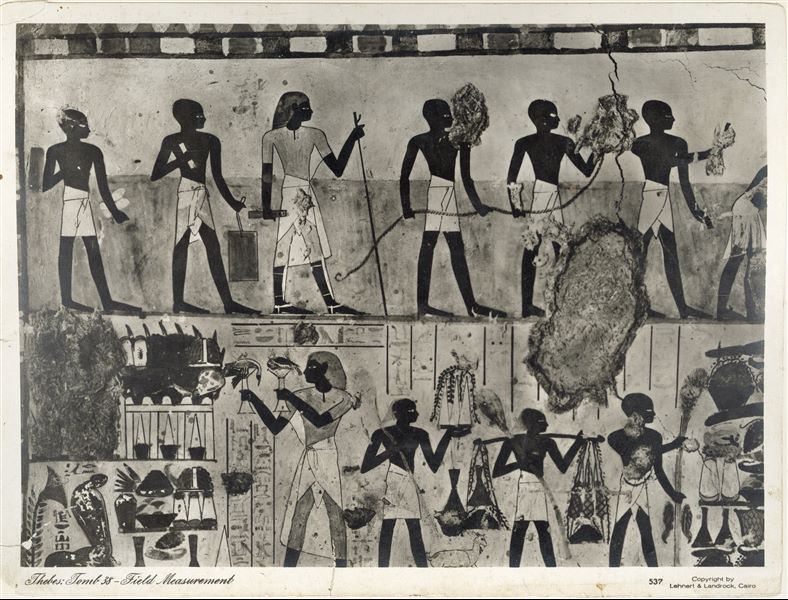 Wall painting scene from the Tomb of Djeserkaraseneb (TT38) (transverse chamber, east wing), who lived in the second half of the 18th Dynasty. In the upper register, the deceased performs some of his duties in the company of some assistants. In the lower register, the deceased makes offerings to Amun and Renutet. The photograph documents a wall that is in a more damaged condition today. The company Lehnert and Landrock (Egypt) was founded in the 1920s, therefore the photograph was taken later. Photograph probably taken by Rudolph Lehnert. 