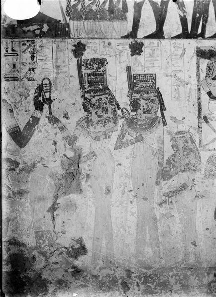 East wall, south side (left of the entrance) of the transverse chamber from the tomb of Menna (TT69). The deceased is seated in front of his three daughters, two are holding sistrums. 