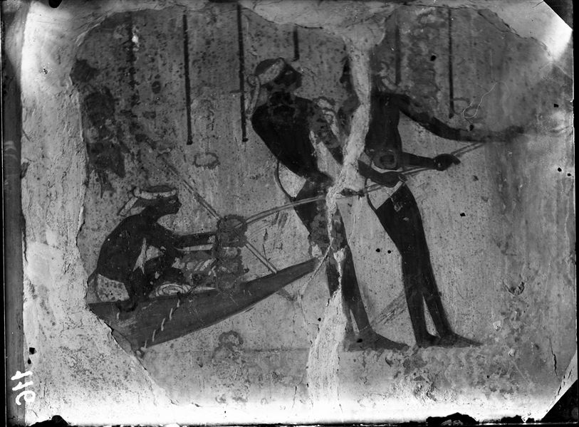 North wall from the second chamber in the tomb of Horemheb (TT78). Detail of two men pulling a fishing net, full of fish (which are not visible in this photograph). 
