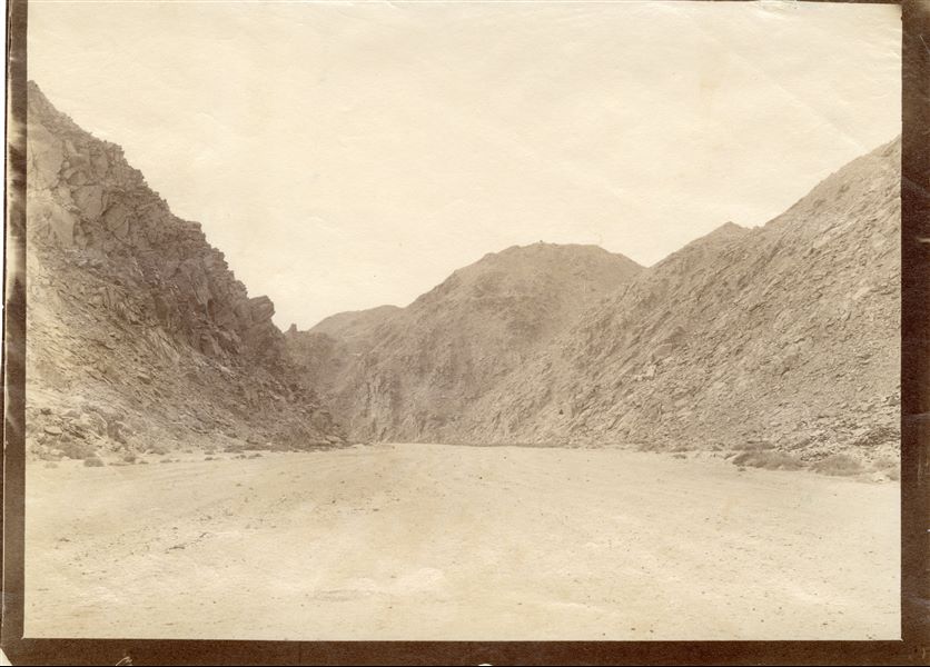 Photograph taken inside the bed of a wadi, presumably near the Valley of the Kings. 
