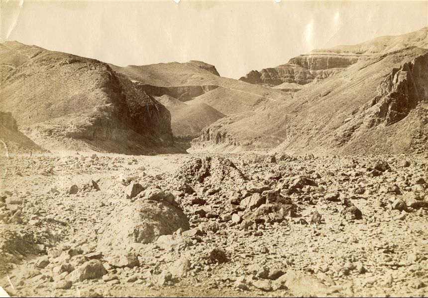 The photograph shows the desert landscape near the entrance to the Valley of the Kings on the west bank of the Nile at Thebes. 