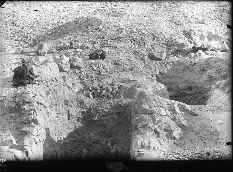 Excavating on the southern slope of the Valley of the Queens. The excavation is focused on tomb QV36 (the opening on the left, where a worker can be seen) and the nearby tomb QV37 (the shaft on the right). Schiaparelli excavations.