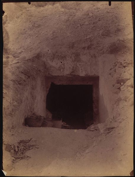 External view of the entrance to the tomb of Khaemwaset (QV 44), son of Pharaoh Ramesses III, at the time of its discovery. Inside, there are still numerous coffins from later periods that were found when the tomb was opened, waiting to be transported to the mission’s camp. In fact, two of these can still be seen in the darkness of the tomb's transverse chamber. Schiaparelli excavations. 