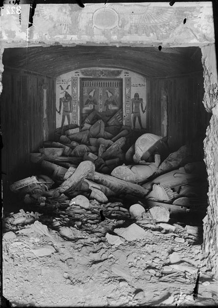 Burial chamber of the tomb of Prince Khaemwaset (QV44) at the time of its discovery on February 15th 1903. More than forty wooden sarcophagi were found from a later period (25th-26th Dynasties), when the tomb was reused. Photograph taken from the vestibule. Schiaparelli excavations. 