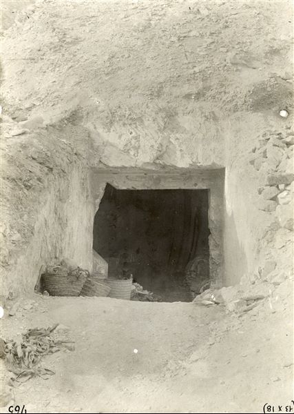 External view of the entrance to the tomb of Khaemwaset (QV 44), son of Pharaoh Ramesses III, at the time of its discovery. Inside, there are still numerous coffins from later periods that were found when the tomb was opened, waiting to be transported to the mission’s camp. In fact, two of these can still be seen in the darkness of the tomb's transverse chamber. Schiaparelli excavations.