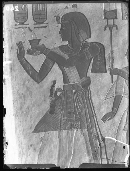 West wall of the vestibule (scene 5) from tomb QV44, depicting Ramesses III offering an incense-burner to the god Atum (not visible in this photograph). The image of Atum (nowadays poorly preserved) is on the recessed wall that separates the vestibule from the burial chamber. Schiaparelli excavations.