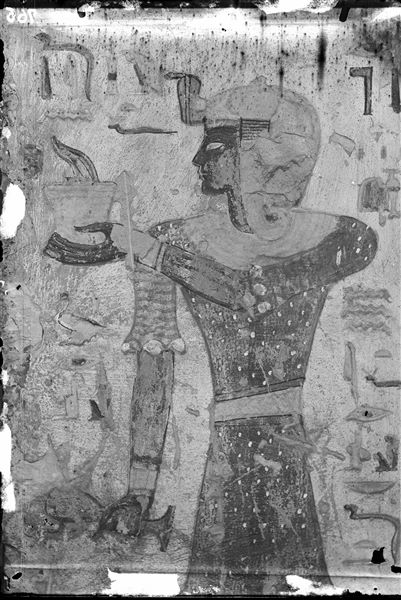 Wall to the left of the entrance of the burial chamber from the tomb of Tyti (QV52). Depicting the god Iunmutef, performing a libation offering. Schiaparelli excavations.