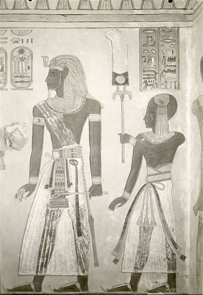 Right wall from the burial chamber from the tomb of Prince Amonherkepeshef (QV 55). Pharaoh Ramesses III and his young son Amonherkepeshef are depicted. On the right, the figure of the god Iunmutef, wearing the typical leopard skin robe can be made out on the right wall of the entrance to the burial chamber. Schiaparelli excavations.