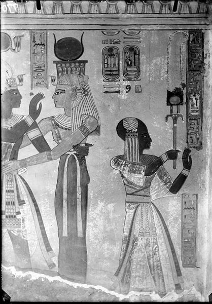 East wall (left) from the antechamber of the tomb of Amonherkhepeshef (QV55). The goddess Isis is embracing Pharaoh Ramesses III, while Prince Amonherkhepeshef is visible on the right. Schiaparelli excavations.