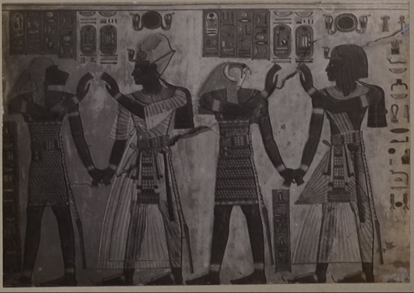 West wall, with the corner of the south wall from the tomb of Prince Amonherkepeshef (QV 55). Two scenes are depicted, where Pharaoh Ramesses III wearing different clothing gives his hands to Hapy (left scene) and Duamutef (right scene), two of the four funerary deities. Schiaparelli excavations.