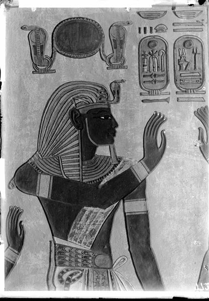 East wall (left) from the antechamber of the tomb of Amonherkhepeshef (QV55). Detail of Pharaoh Ramesses III, wearing the nemes headdress and holding hands with the funerary deity Imseti; not visible in this photograph. Schiaparelli excavations. 