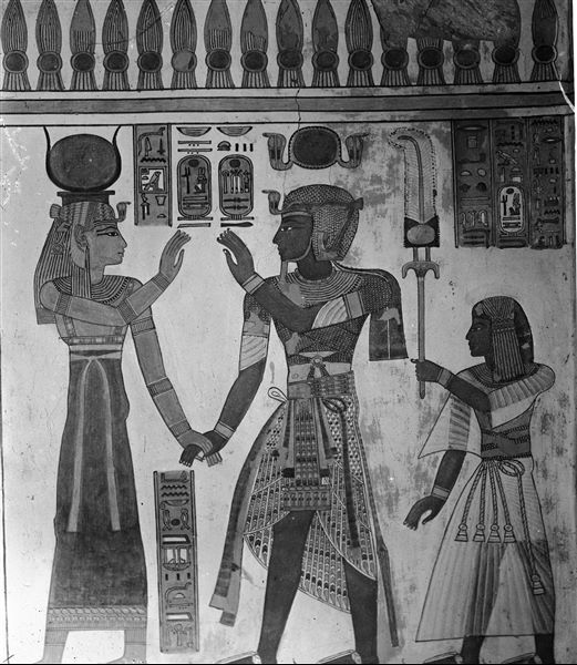 South wall (back), from the antechamber of the tomb of Amonherkhepeshef (QV55), west side (right). Depicted starting from the right: the young Amonherkhepeshef, his father Pharaoh Ramesses III who holds hands with the goddess Hathor. Schiaparelli excavations.