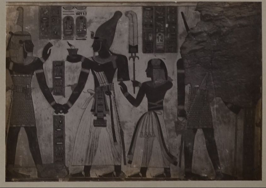 West (right) wall of the transverse chamber from the tomb of Prince Amonherkepeshef (QV 55). Depicted from the left are: the god Shu, Pharaoh Ramesses III, and his son: the young Prince Amonherkepeshef, to whom the tomb belongs. It is difficult to distinguish the last figure on the right; however, it is a deity. 
