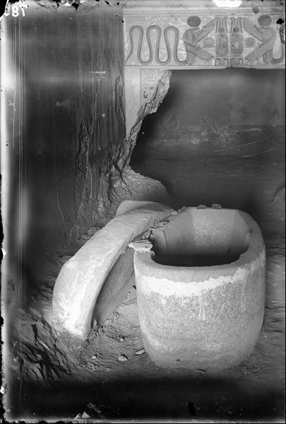 Inside the tomb of Prince Amonherkhepeshef (QV55), at the time of discovery. In the foreground, the prince's granite sarcophagus in his burial chamber. Schiaparelli excavations. (Original label: The pink granite sarcophagus, as it was found).