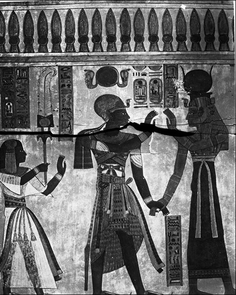 South wall (back) from the antechamber of the tomb of Amonherkhepeshef (QV55), east side (left) of the access to the rear annex. The goddess Isis holds the hand of Pharaoh Ramesses III. On the left is Amonherkhepeshef. Schiaparelli excavations.