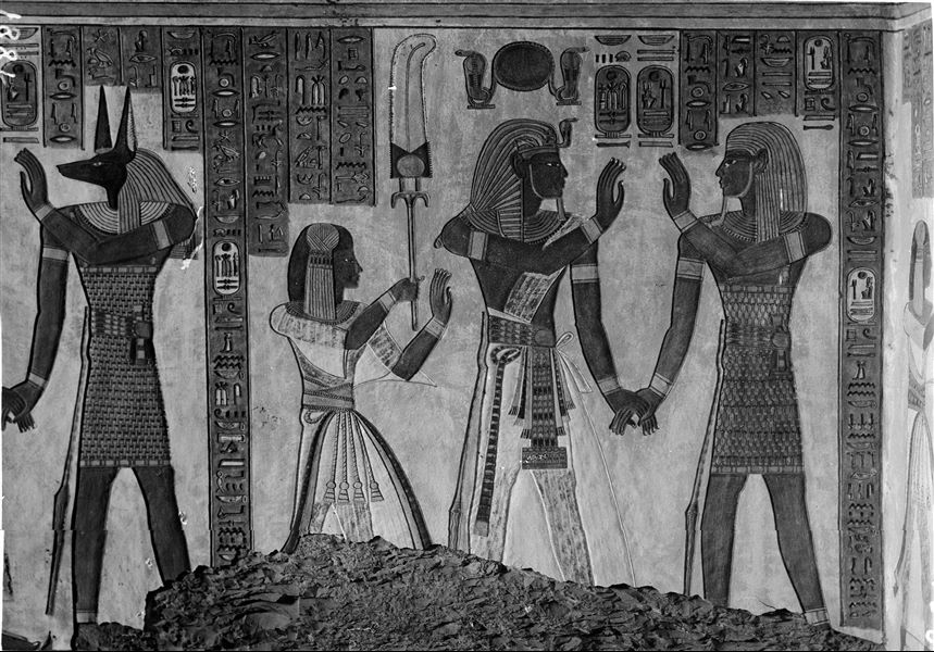 East wall (left) from the antechamber of the tomb of Amonherkhepeshef (QV55). In this photograph two scenes can be observed. In the first one, the funerary deity Duamutef holds the hand of Ramesses III; not visible in this image. In the second one, Ramesses III holds the hand of the funrary deity Imseti. Behind the Pharaoh is his son, Amonherkhepeshef. Schiaparelli excavations. 