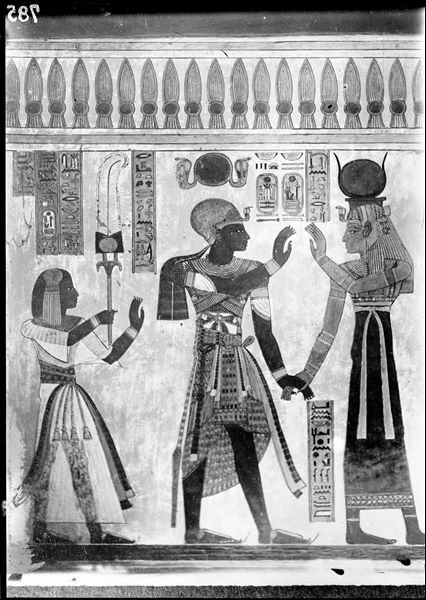 South wall (back) from the antechamber of the tomb of Amonherkhepeshef (QV55), east side (left) of the access to the rear annex. The goddess Isis holds the hand of Pharaoh Ramesses III. On the left is Amonherkhepeshef. Schiaparelli excavations. 