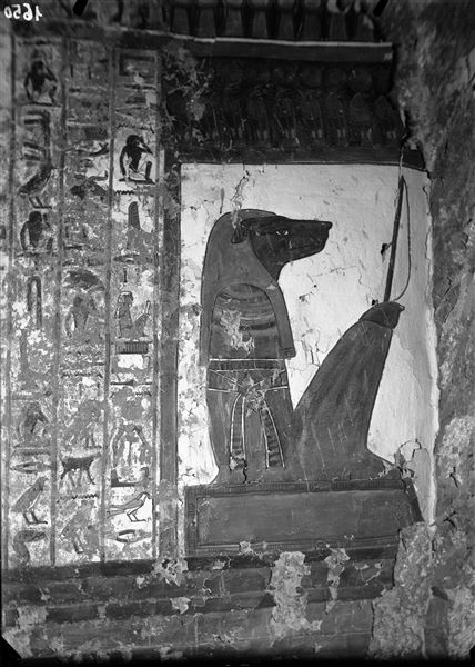 Burial chamber, north wall, scene 35. Continuation of the text from Spell 146 of the Book of the Dead. The tenth gate and its canine-headed guardian can be seen. In recent times, a part of the plaster from this wall has collapsed. 