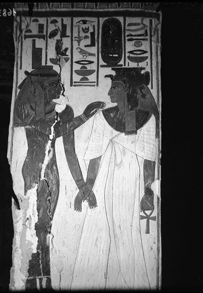 View of pillar D, side c, from the burial chamber. Queen Nefertari on the right and the goddess Isis on the left can be seen holding hands. 