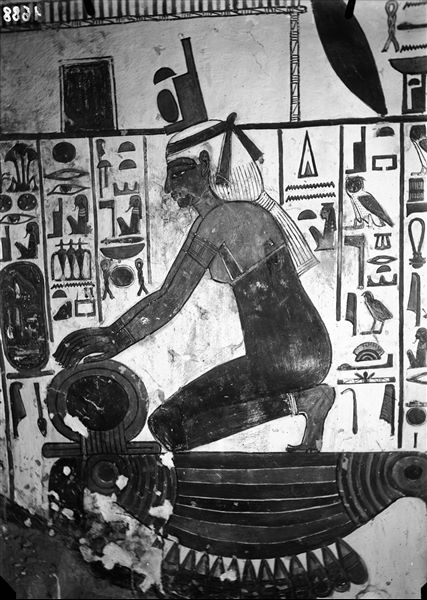 Descending corridor, west wall, scene 26. Detail of the goddess Isis kneeling above a representation of the hieroglyph Nbw meaning 'gold'. Her hands are resting on another hieroglyphic symbol, the Shen-sign.