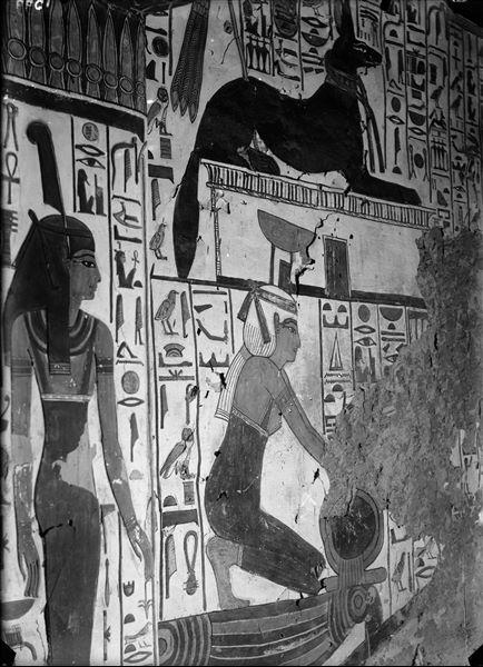 Descending corridor, east wall, scene 27. On the left, the goddess Maat (scene 28, depicted on the right side of the access to the burial chamber), on the right, the goddess Nephthys is kneeling. Visible in the upper register is the god Anubis in his animal form, above a shrine. The inscriptions shown are benevolent expressions uttered by the two deities to Nefertari.