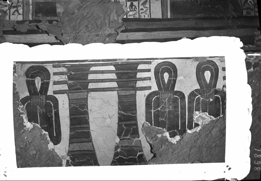 Burial chamber, east wall, wall decoration consisting of pairs of Djed pillars alternating with pairs of Tit knots. This decoration is in the register below the text from Spell 146 of the Book of the Dead, under the fourth and fifth gates. In recent times, part of the plaster from this wall has collapsed.