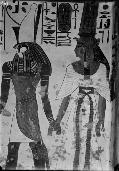 South wall of the vestibule, scene 7. The god Horus wearing a double crown or Pschent leads Nefertari by the hand.