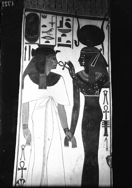View of pillar C, side d, from the burial chamber. Queen Nefertari (left) and the goddess Isis can be seen holding hands. 