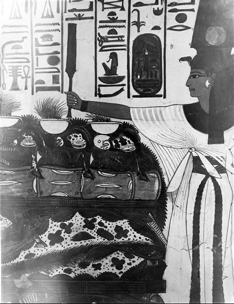 First eastern annex (alcove), east wall, scene 18. Detail of the pile of offerings shown between Nefertari and the seated god Atum. The inscription above shows in one part, Nefertari's invocation with offerings to the god, in the other, the god's benevolent reply. 