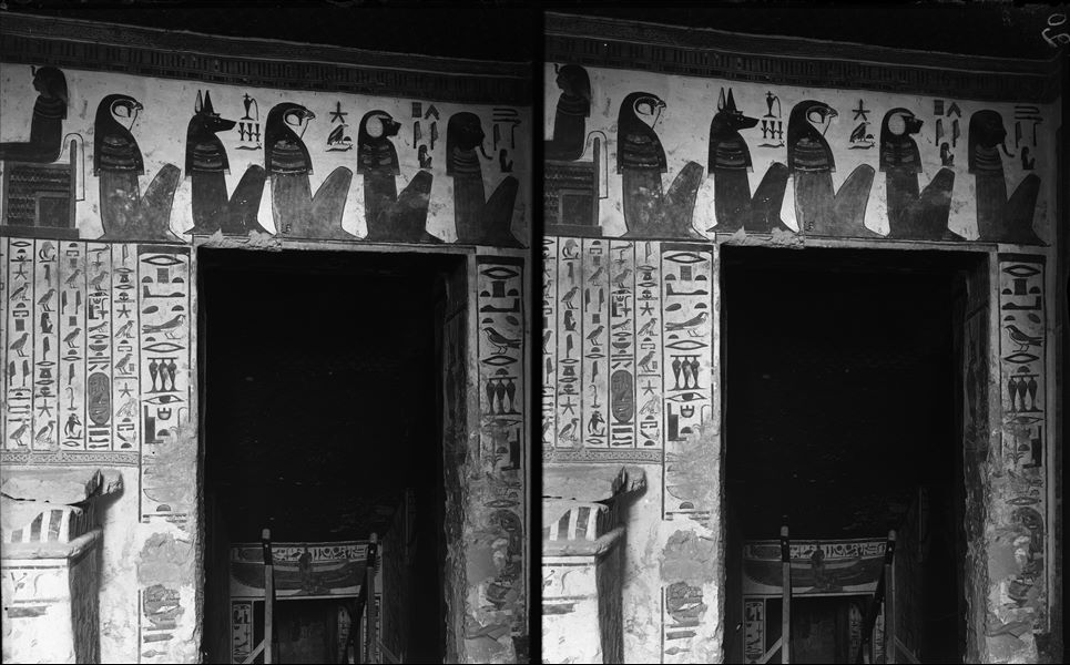 View of the antechamber, north wall, scene 19. From the north wall there is access to the descending corridor leading to the burial chamber. Above the access, scene 19 with the representation of the god Horus and the four sons of Horus (funerary deities): from the right Imseti, Hapy, Duamutef, and Qebehsenuf. 