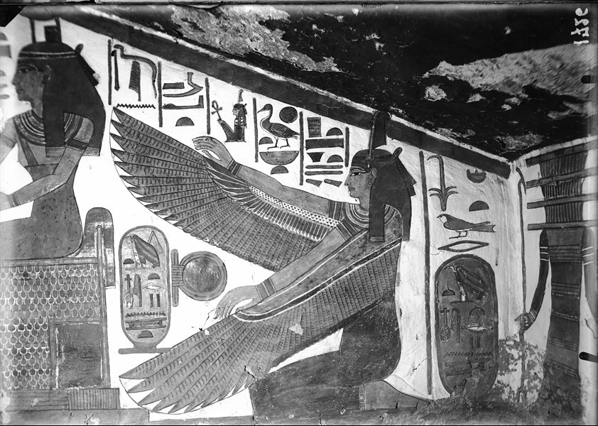 Descending corridor, west wall, scene 22. At the top of the descending corridor are a series of deities receiving offerings from Nefertari. The last deity, occupying the portion of the wall that follows the descent of the room, is the winged goddess Maat shown kneeling.