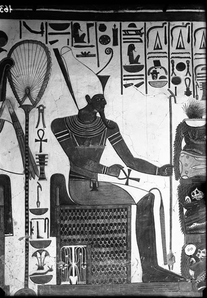 First eastern annexe (alcove), east wall, scene 18. Detail of the god Atum seated and facing south (right), in the act of receiving offerings from Nefertari, not visible here.